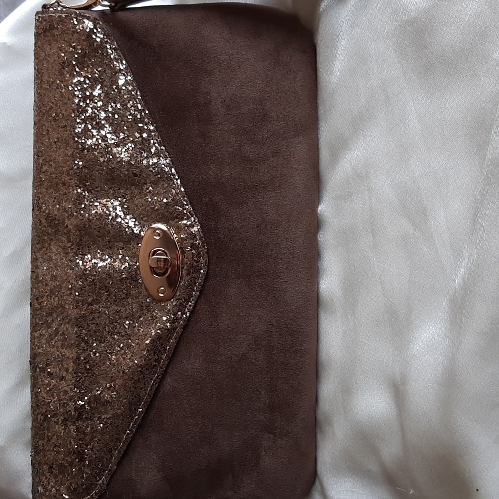 Suede like clutch purse.Detachable wrist strap.  Gold coloured sparkly t…